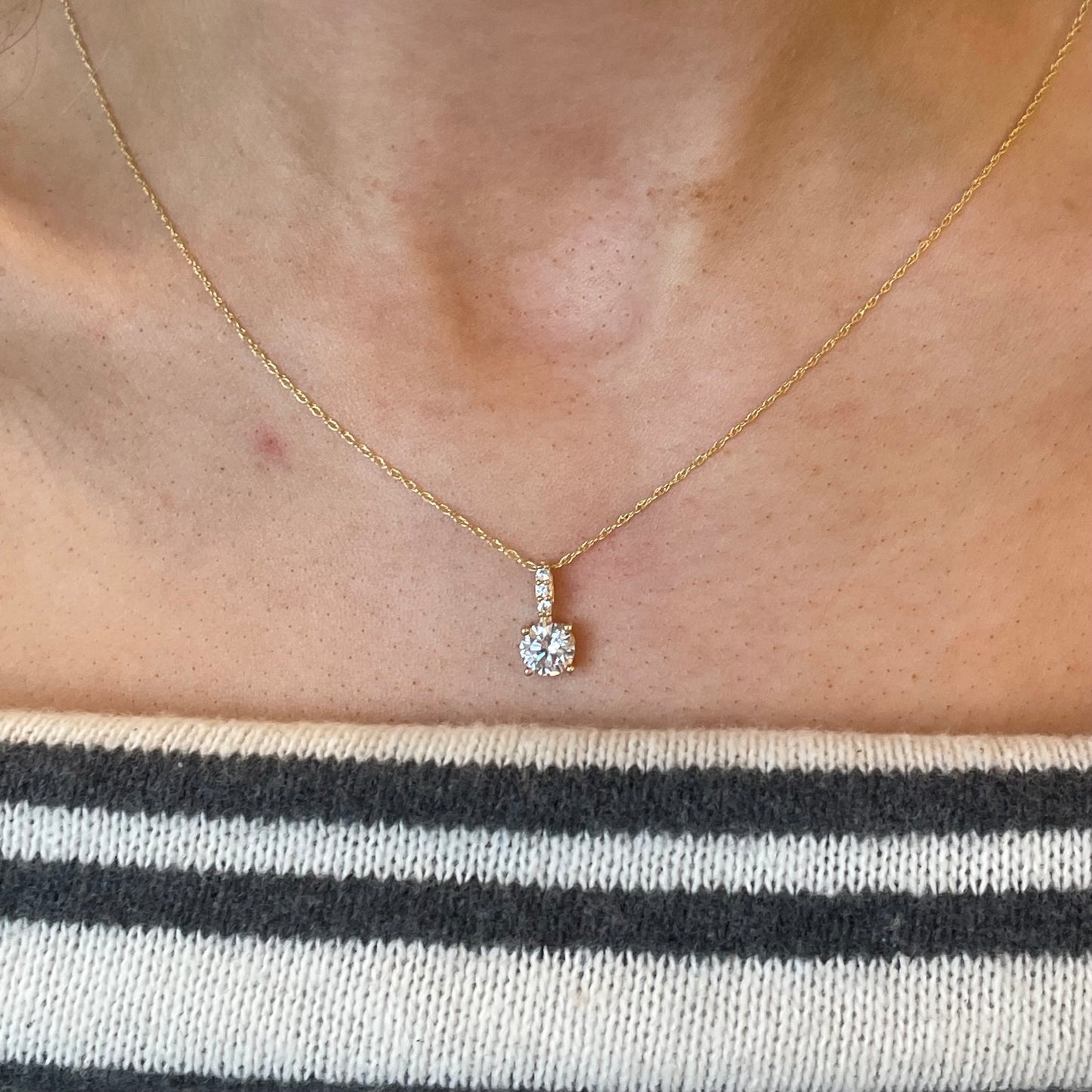 NJO 9ct gold claw set CZ necklace with a 6mm pendant, featuring a sparkling cubic zirconia stone on a delicate chain.