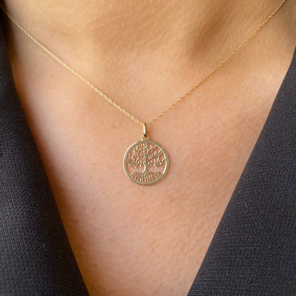 9ct gold Tree of Life necklace with detailed pendant, showcasing intricate design on a delicate chain.