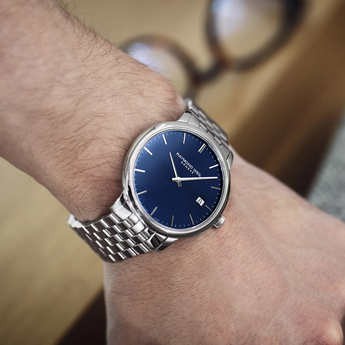 Raymond Weil Classic Toccata 39mm steel watch with blue dial and silver hands, showing the watch face and bracelet details.