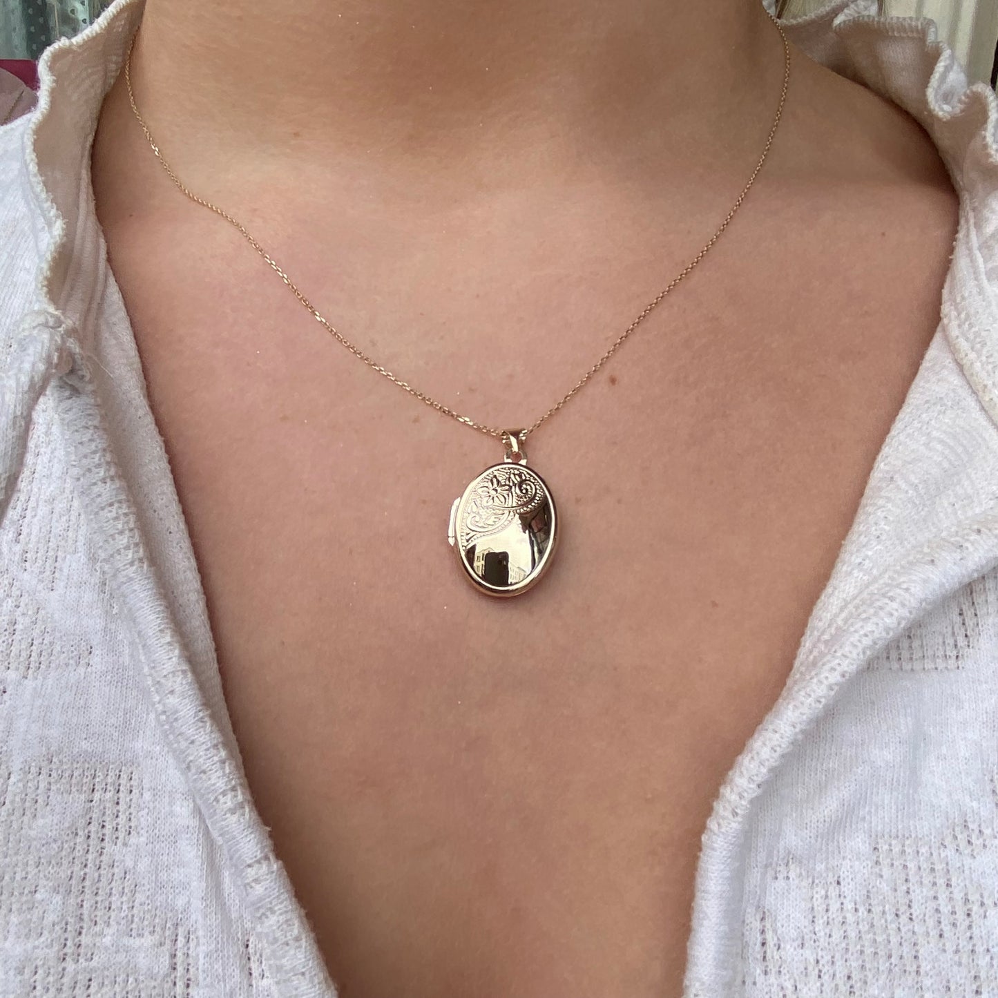 9ct gold engraved oval locket necklace with detailed design, featuring a classic and elegant jewelry piece by PJD.