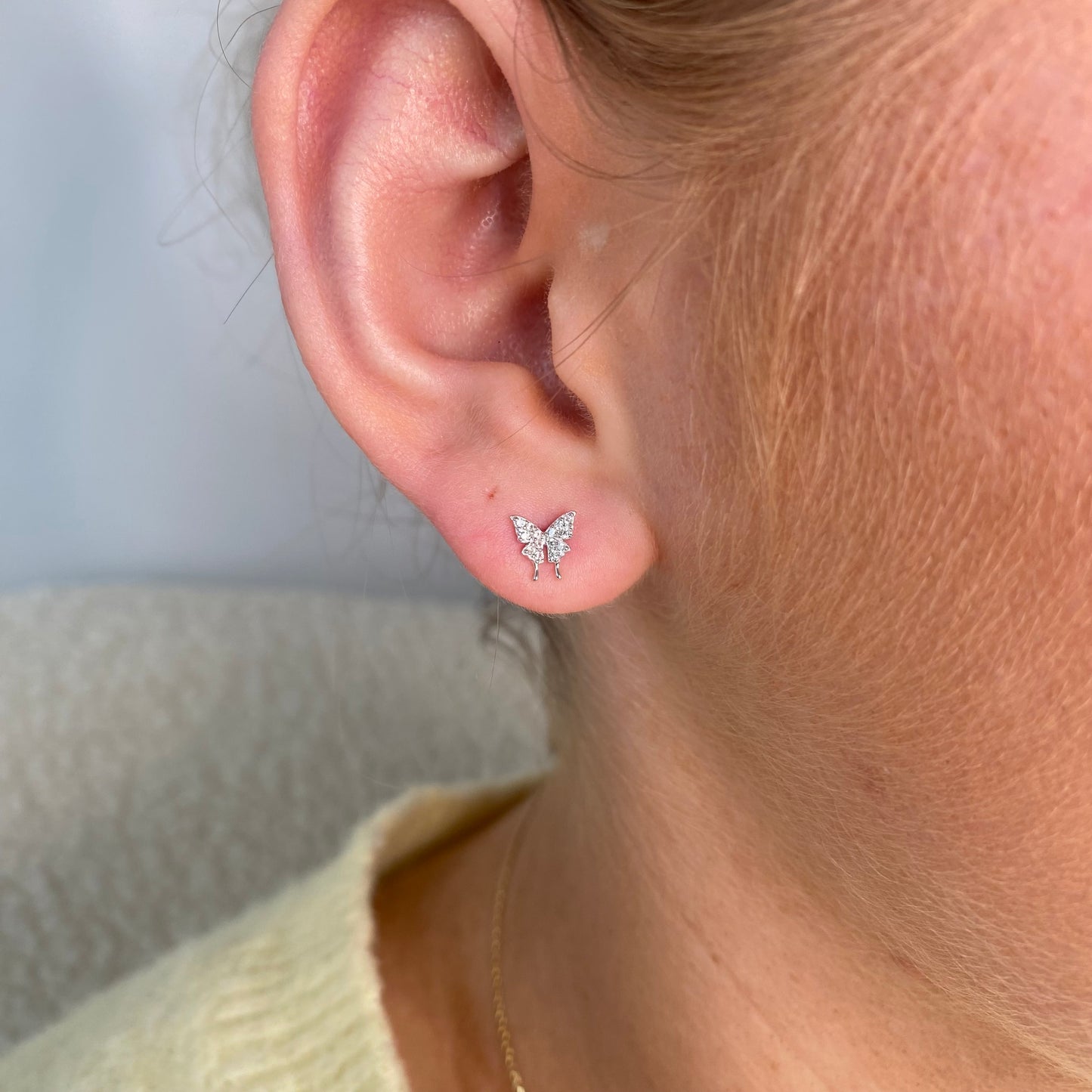 Silver CZ butterfly stud earrings for kids by Comero, featuring sparkling cubic zirconia and a cute butterfly design.