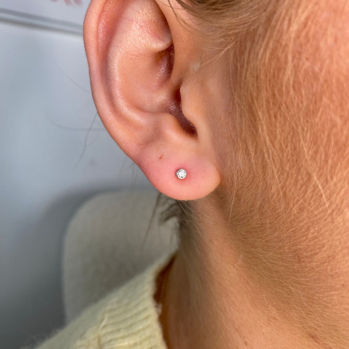 Kid's silver stud earrings with 1mm cubic zirconia bezel set in classic design by Comero.