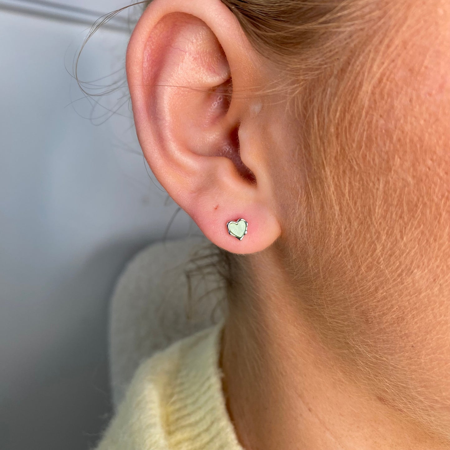 Silver enamel heart stud earrings for kids in green by Comero, featuring cute heart-shaped design with vibrant green enamel.