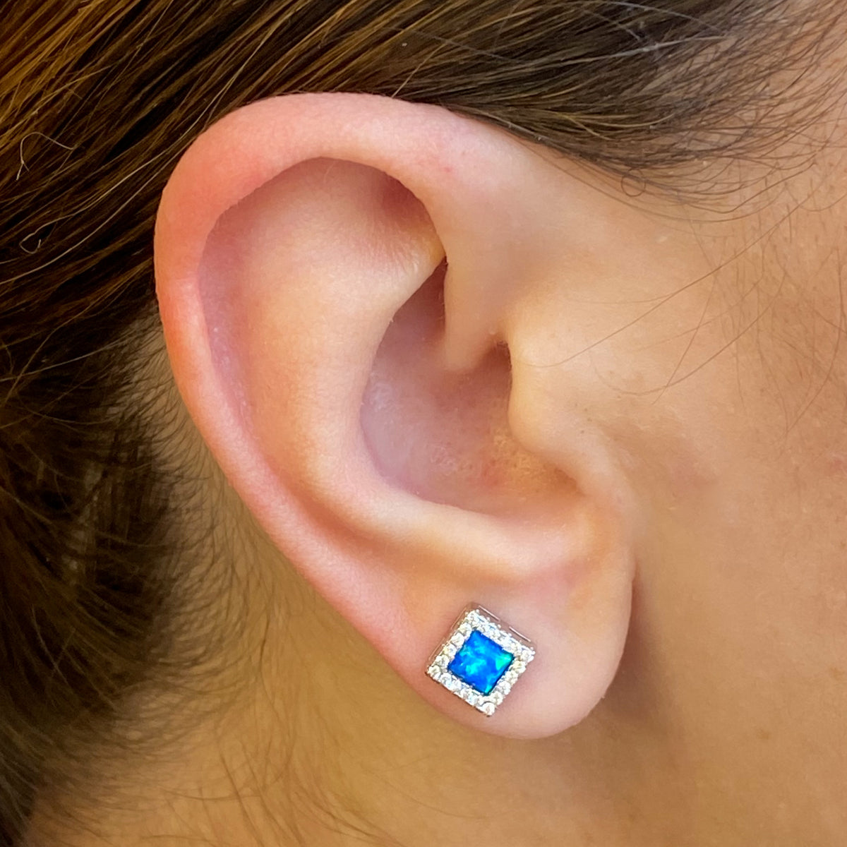 Silver square earrings with blue opalique and CZ halo, Insignia stud earrings showcasing sparkling gemstone accents.