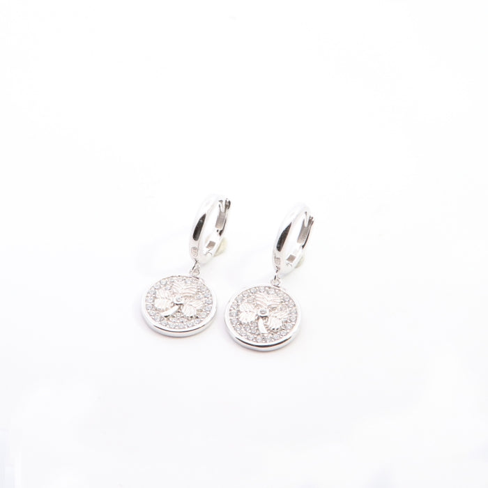 Silver CZ shamrock charm hoop earrings by Comero featuring sparkling cubic zirconia accents and a stylish hoop design.
