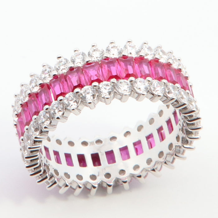 Silver spiky band ring with ruby red accents by Comero, showcasing a bold, edgy design and intricate details.