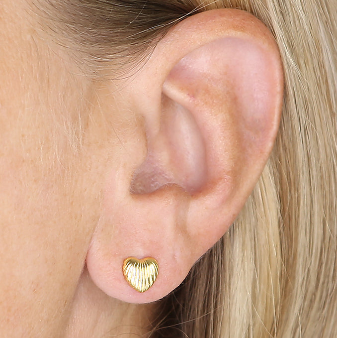 CME Sunshine ribbed heart stud earrings in gold, showcasing a textured design and elegant heart shape on a white background.