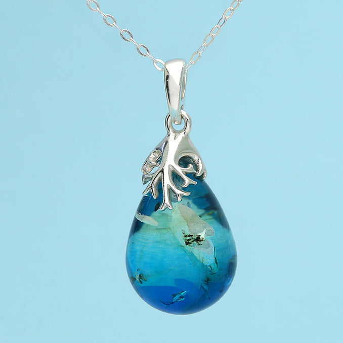 Silver Baltic Amber pendant necklace with a polished amber stone on a silver chain, crafted by CME.