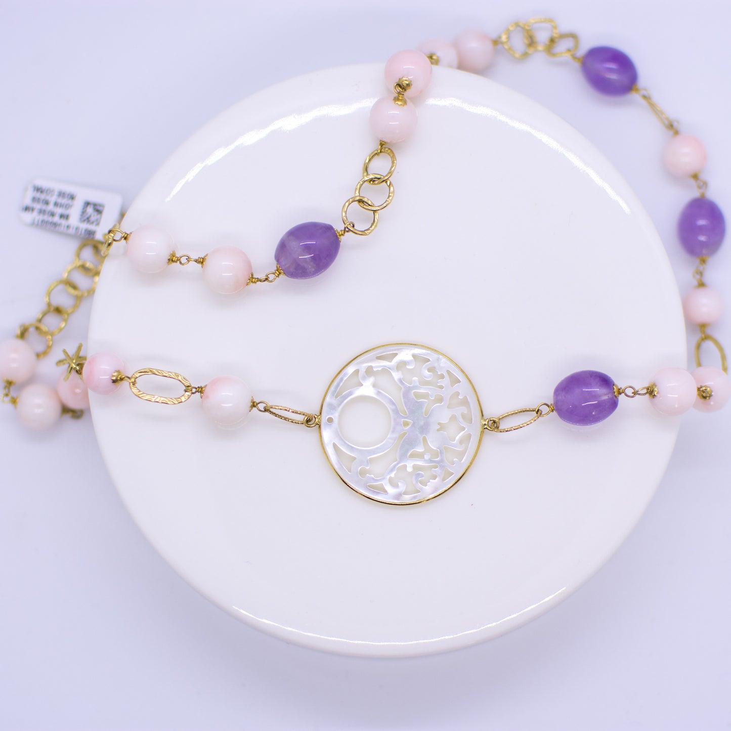 18ct Gold Mother of Pearl fancy cut out, Rose Coral bead and Silky Amethyst Necklace Asymmetrical pattern with the Mother of Pearl cut out positioned on the collarbone. This necklace is hand made an features fancy round, oval and square links. 52cm necklace 18ct yellow gold