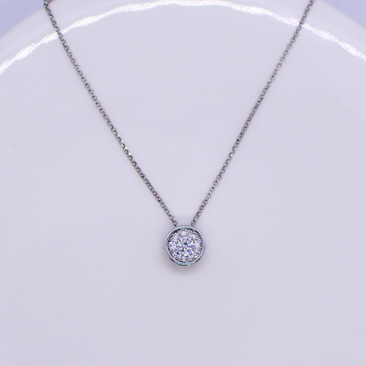 This diamond slider necklace is fabulous choice if you are looking for a super wearable diamond set necklace. A cluster of round brilliant cut diamonds gives a solitaire look. 0.35ct GVS in total approximately. 18ct white gold. The chain passes through the pendant. 42cm-45cm adjustable 18ct white gold fine diamond cut belcher chain with lobster clasp.