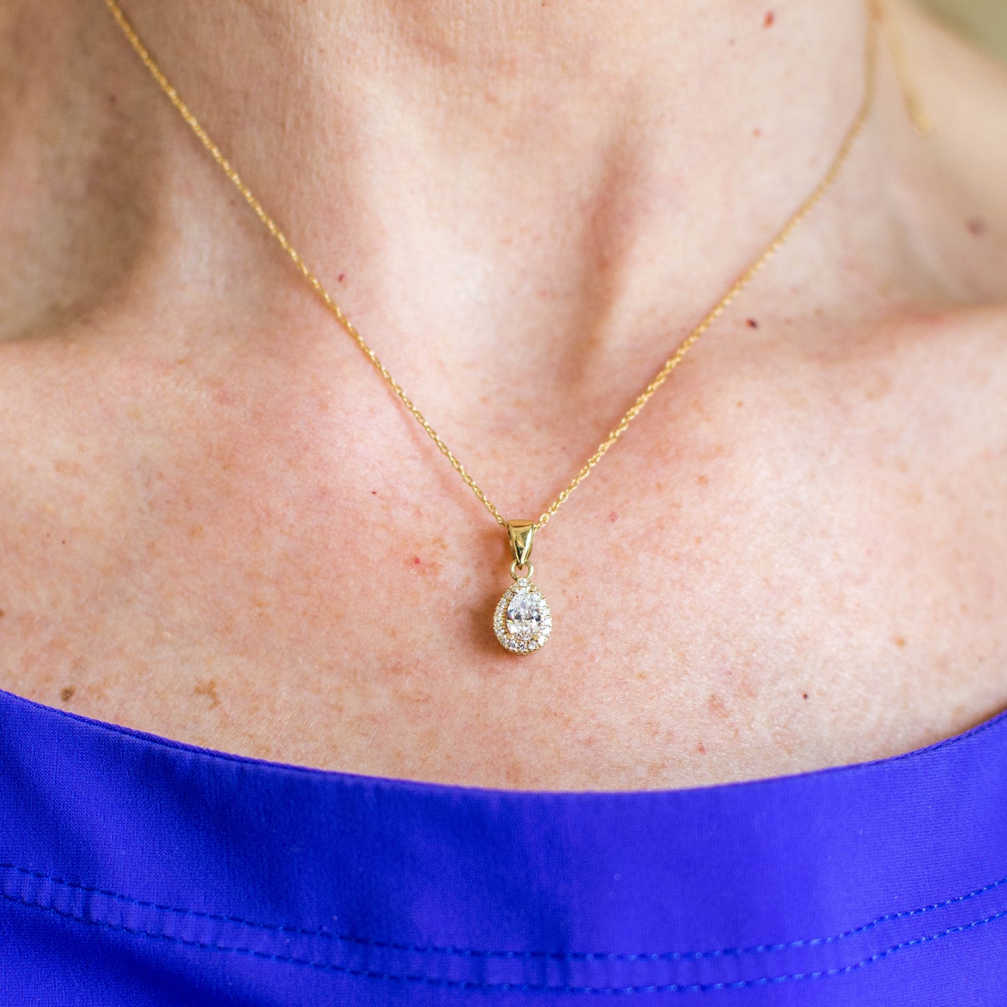 9ct gold pear-shaped CZ halo necklace by Mark Milton, featuring a sparkling pendant on a delicate chain.