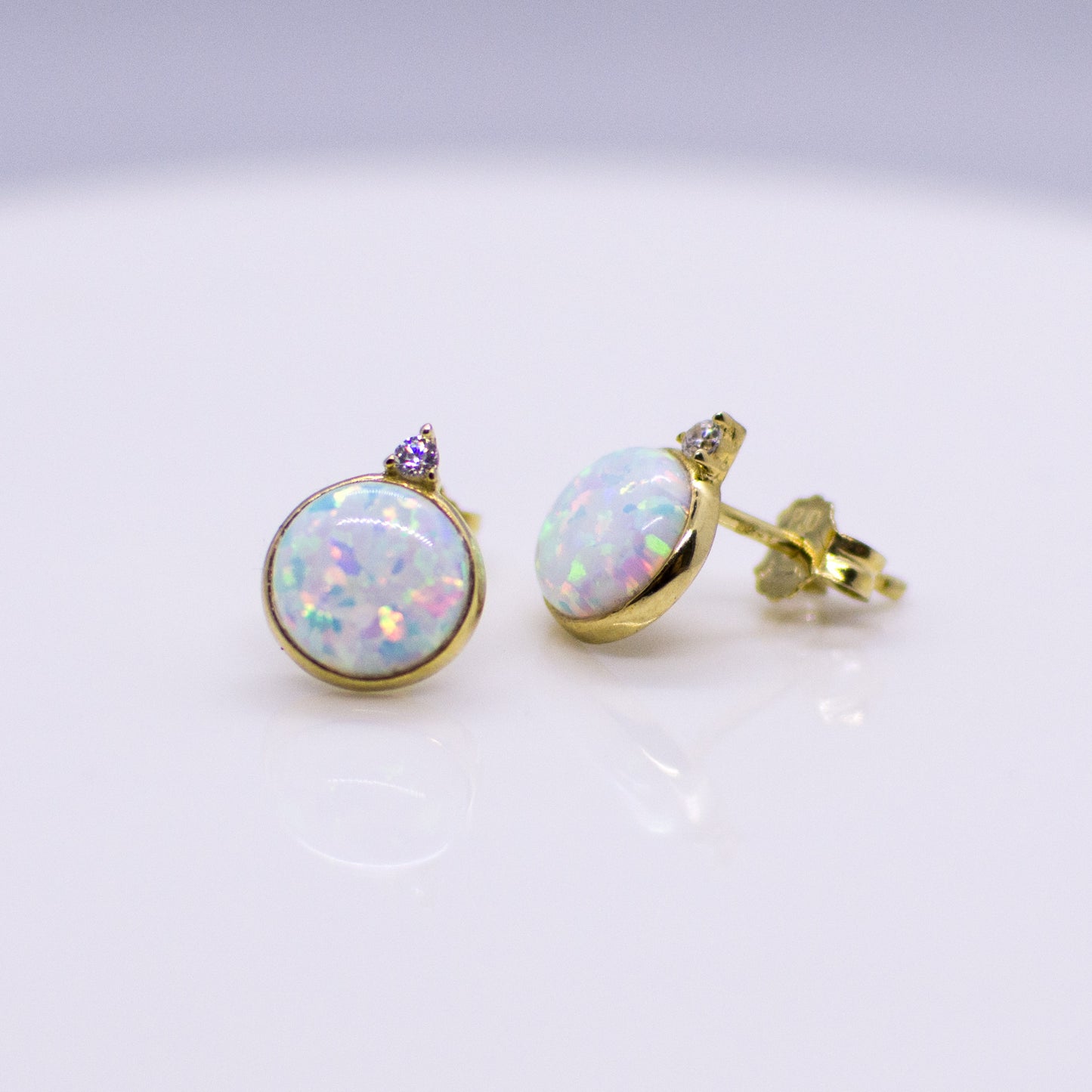 9ct gold Opalique CZ stud earrings featuring sparkling cubic zirconia stones, crafted by PJD, with a classic and elegant design.