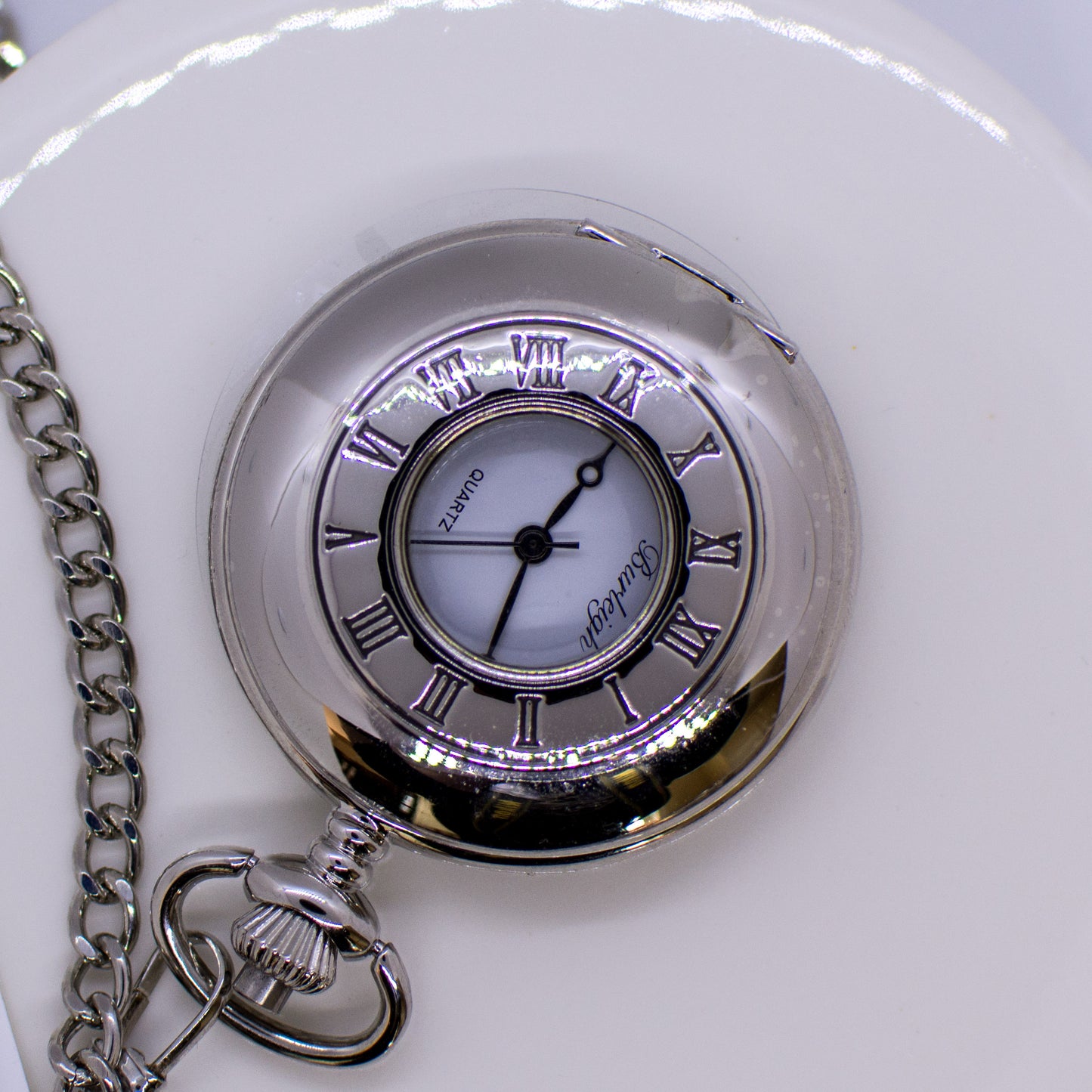 Silver Harrison half hunter pocket watch with open face and classic design, showcasing the intricate dial and vintage style.