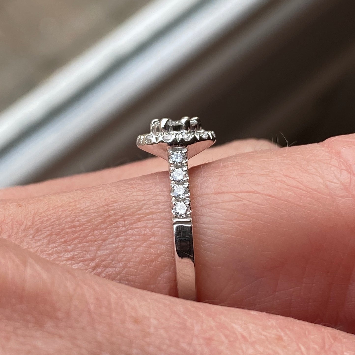 This round cluster diamond engagement ring is a complete classic. Its simplicity is so romantic. The Details... One 18ct white gold diamond engagement ring. Diamond halo cluster with diamond-set shoulders. 0.66ct in total of round brilliant cut diamonds. Colour GH. Clarity SI. 18ct white gold, Pure White (tm) nickel-free. Size N.