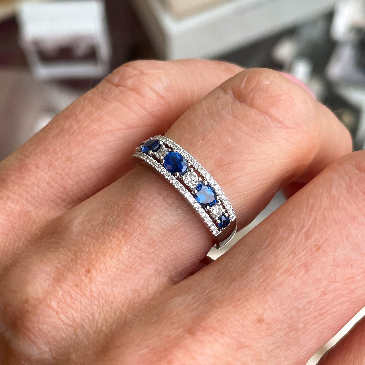 18ct white gold sapphire and diamond eternity ring by MNP, showcasing a row of sparkling gemstones around the band.