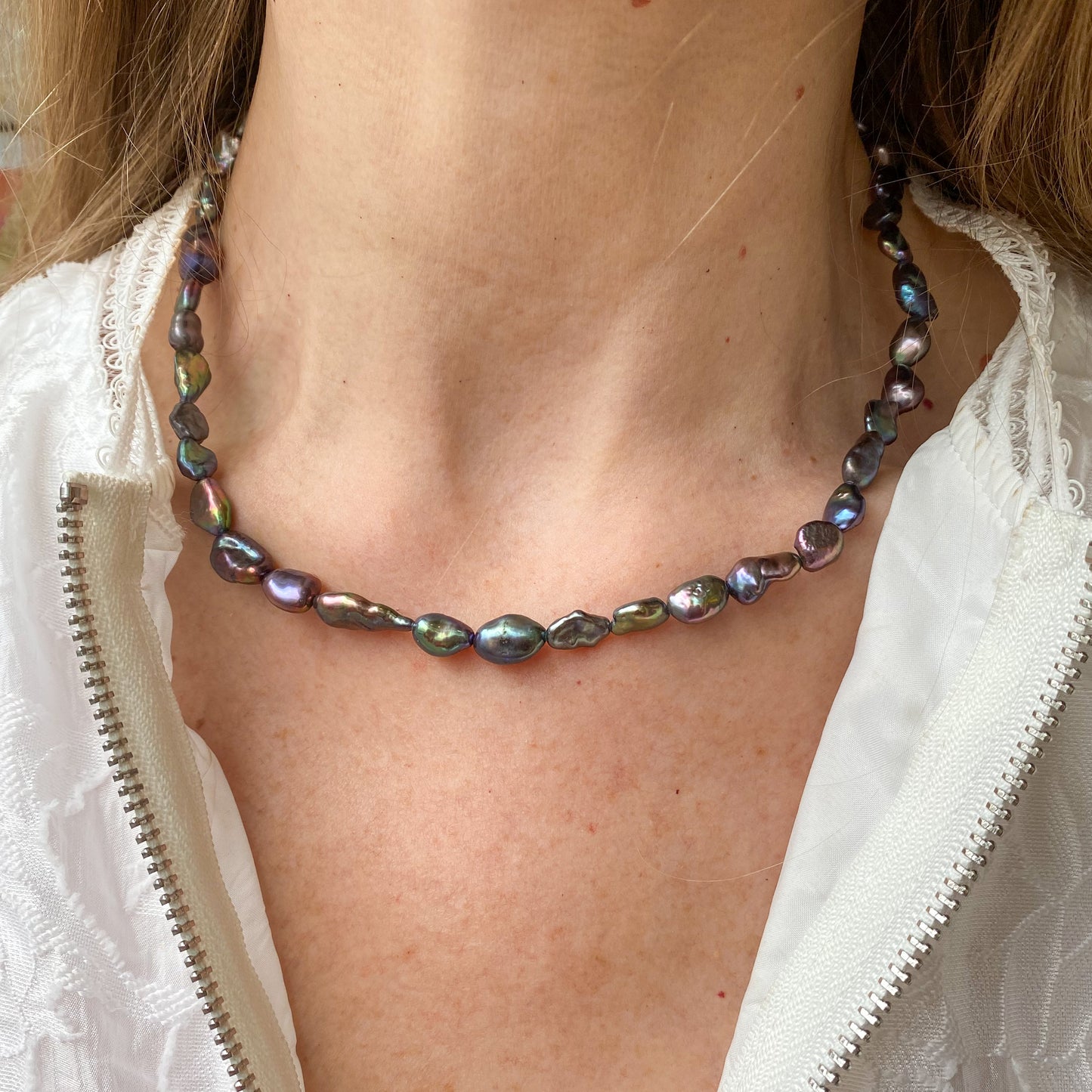 Anthracite Keshi freshwater pearl necklace by Di Perle featuring irregular-shaped pearls on a delicate chain.