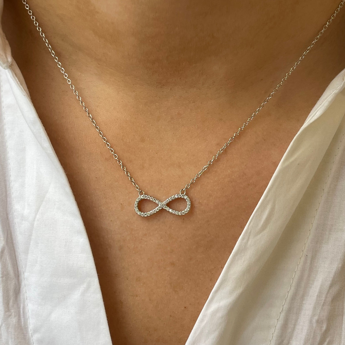 Silver CZ infinity necklace by Insignia featuring a sleek infinity pendant with sparkling cubic zirconia stones.