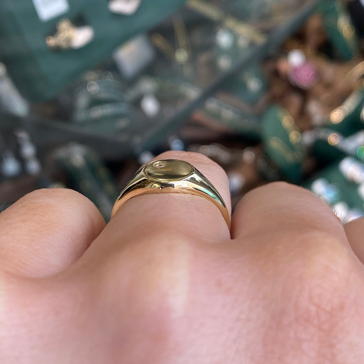 NJO 9ct gold round CZ signet ring featuring a polished gold band and a central cubic zirconia stone.
