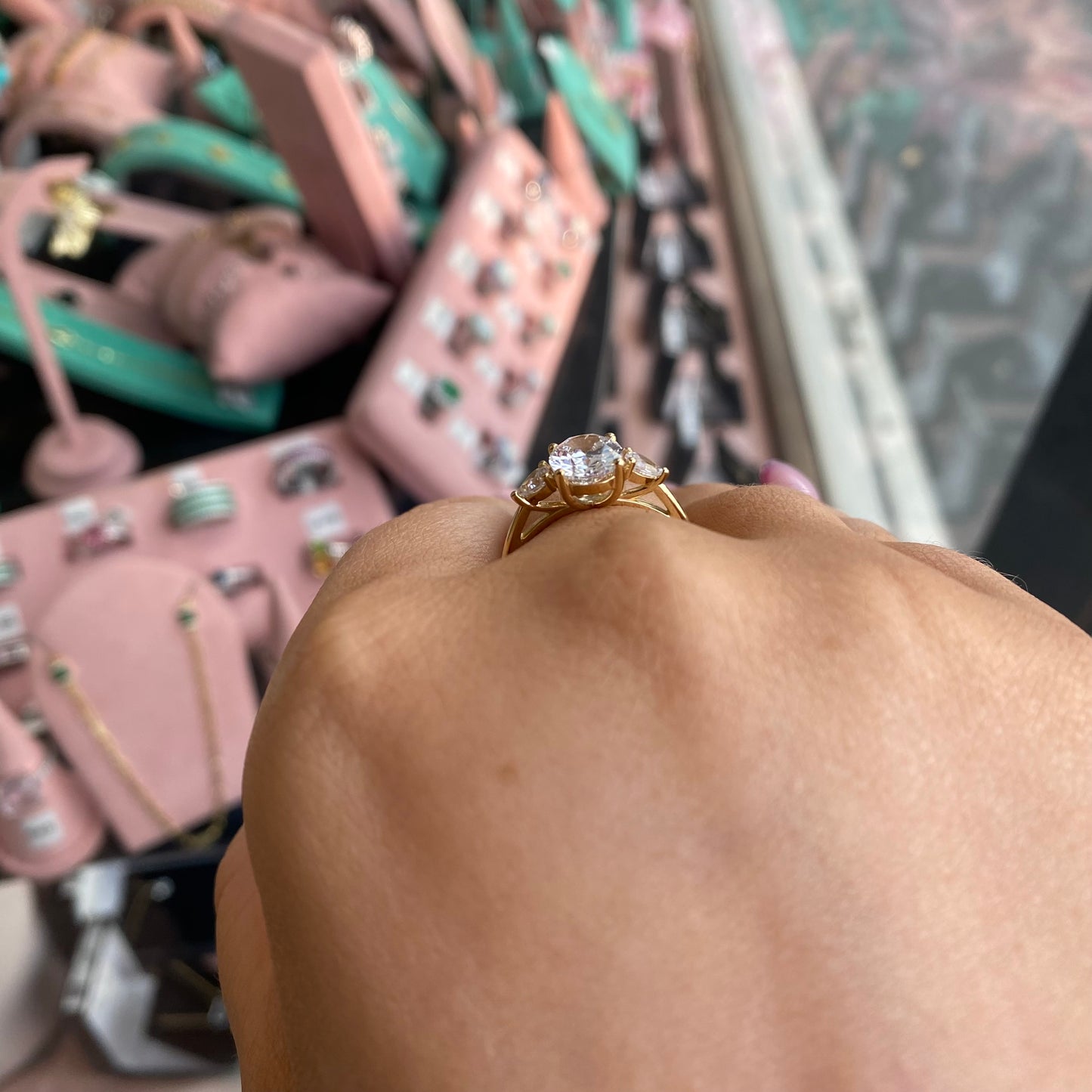 9ct gold CZ trilogy ring with an oval center stone, featuring sparkling cubic zirconia accents in a elegant design.