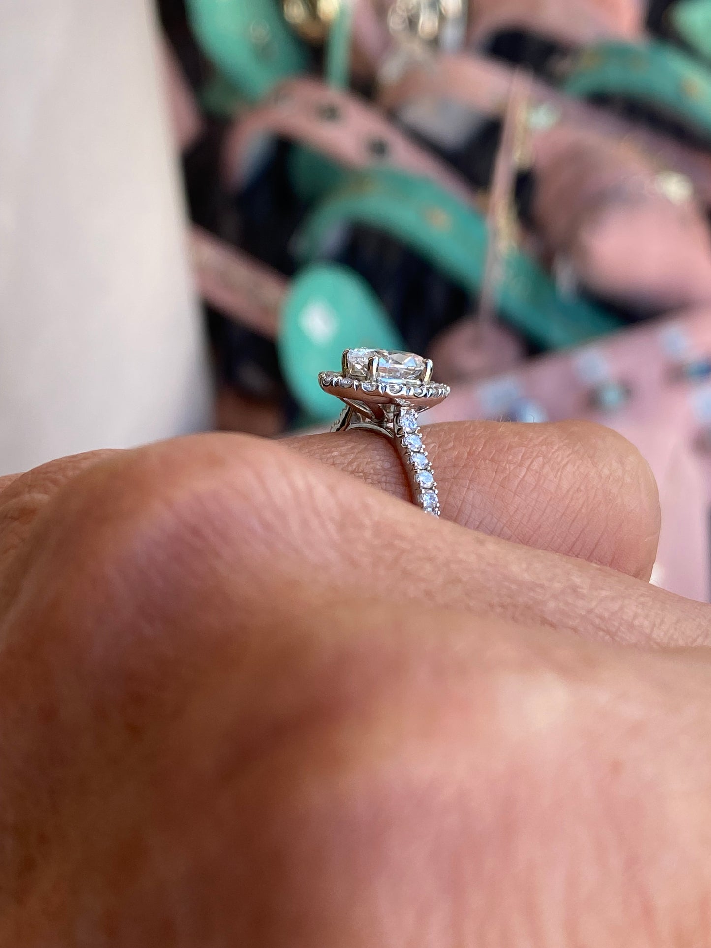 Domino platinum oval halo solitaire engagement ring with 1.00ct center stone and diamond accents, showcased on a white background.
