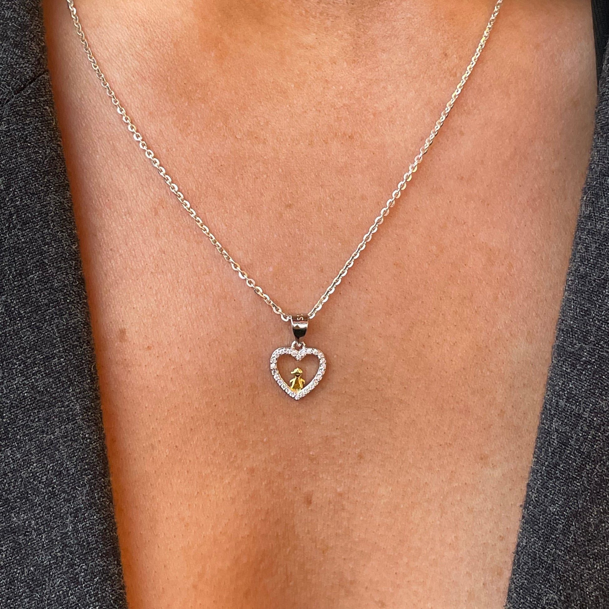 Silver CZ angel heart pendant necklace by Comero featuring a delicate heart-shaped charm with sparkling cubic zirconia.