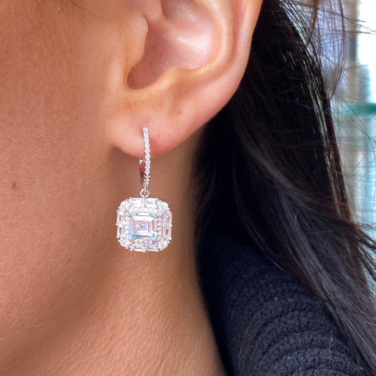 Silver Aqua CZ cushion halo drop hoop earrings by Comero featuring sparkling aqua blue cubic zirconia stones and hoop design.