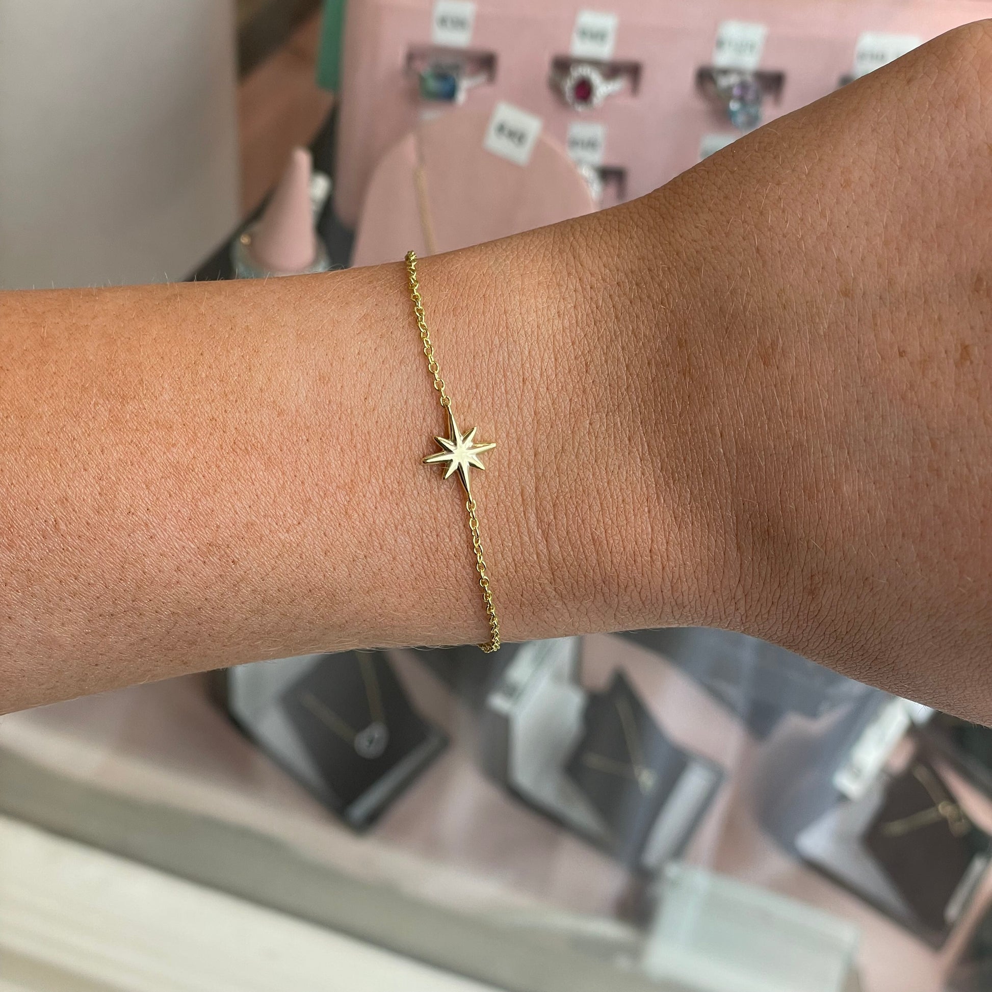 THC Sunshine North Star bracelet with gold-tone star charm and adjustable chain on a neutral background.