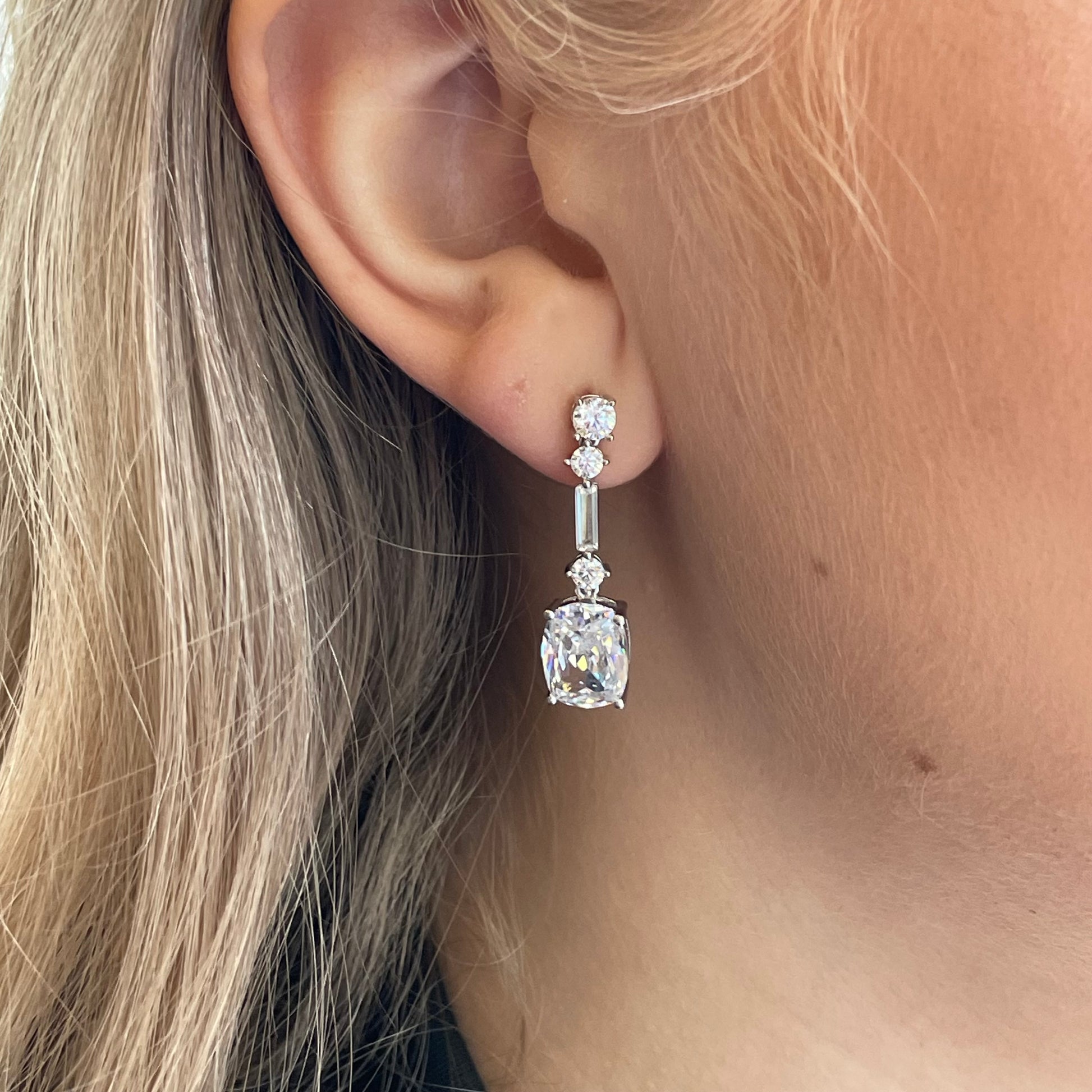 Silver C-Flawless Elongated Cushion CZ Drop Earrings by Insignia featuring sparkling cubic zirconia gemstones in a sleek drop design.