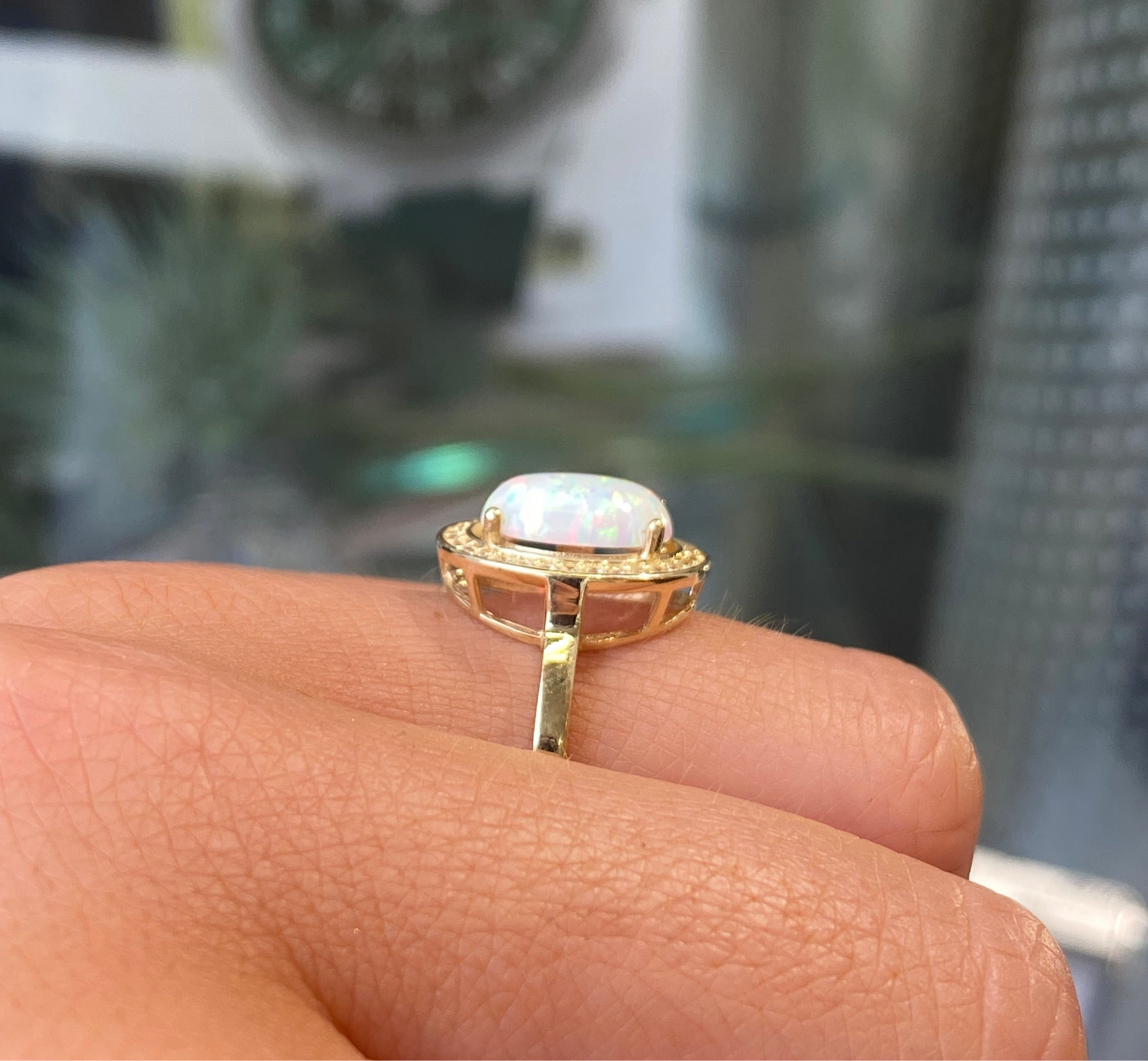 9ct gold oval opalique and CZ ring with a detailed band, showcasing elegant craftsmanship by G Molins & Company Limited.