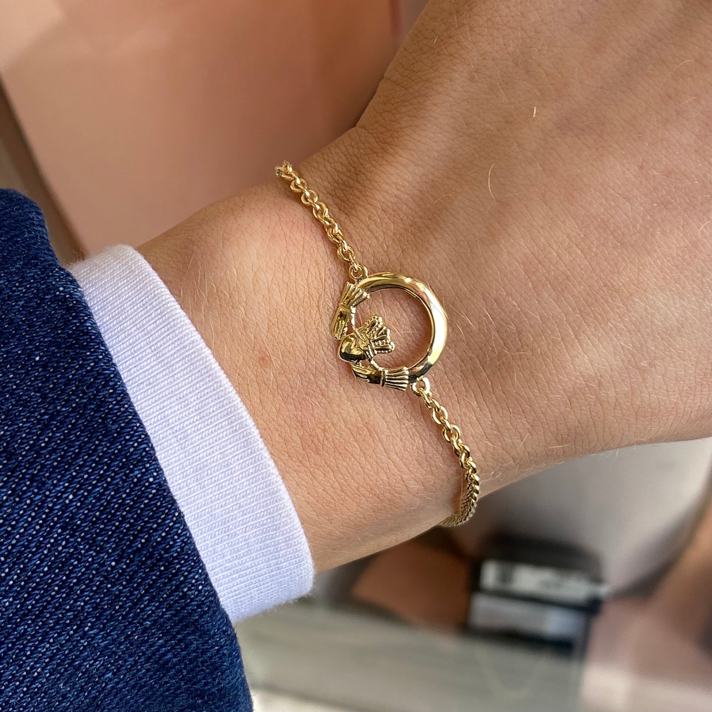 Gold Claddagh bracelet by Facet, 10-carat gold with intricate heart and crown design, displayed on a neutral background.