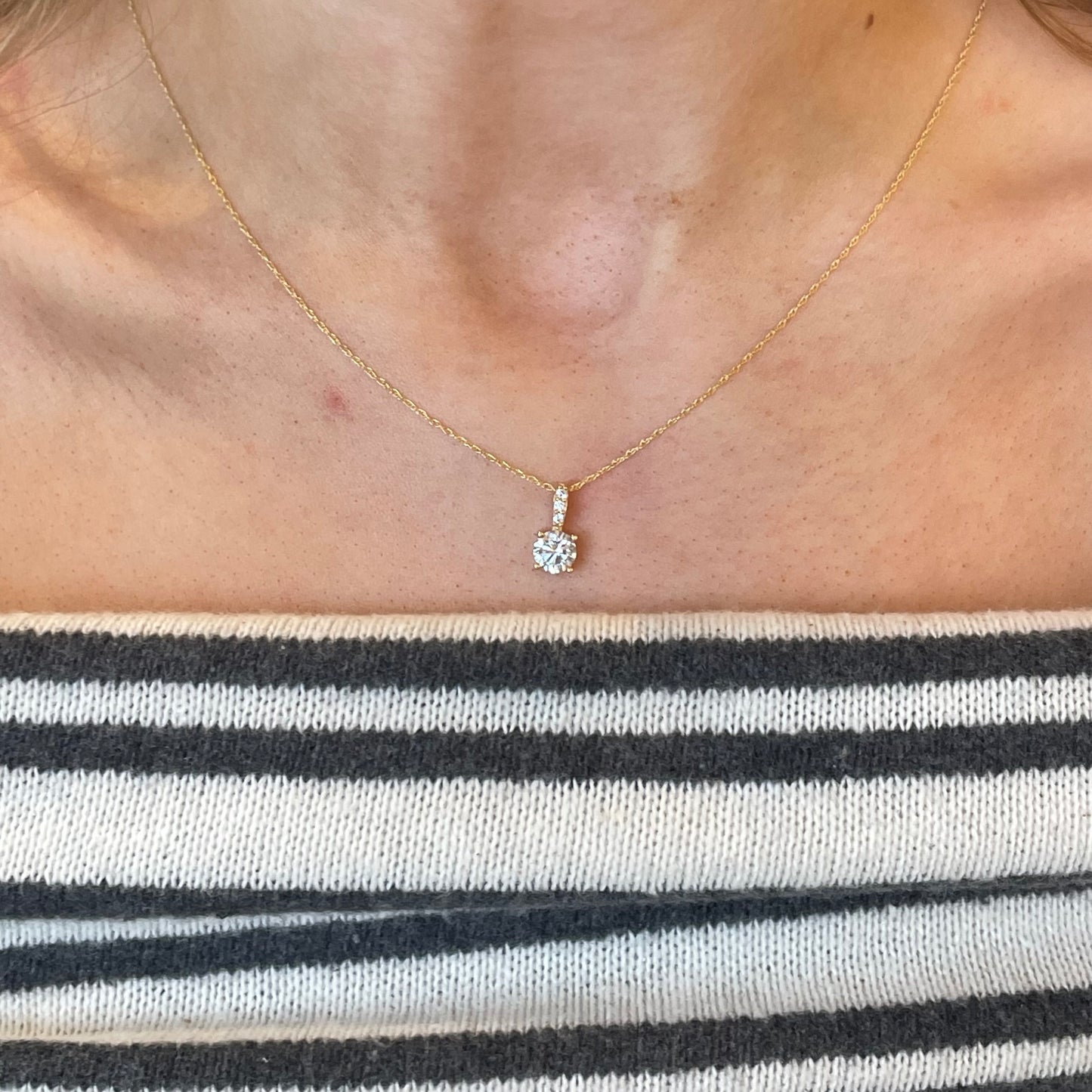 9ct gold claw set CZ necklace with a 6mm pendant, showcasing a sparkling cubic zirconia gemstone on a delicate gold chain.