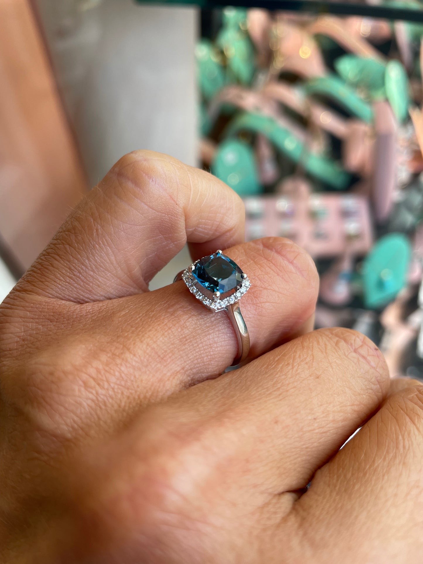 Herbert 9ct white gold cushion cut London Blue Topaz and diamond ring, showcasing a blue gemstone surrounded by small diamonds.
