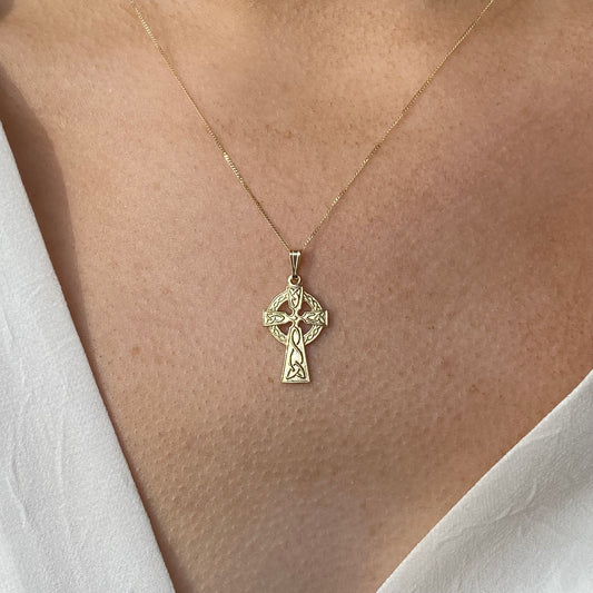 Facet 10ct gold Celtic cross necklace with intricate design, featuring a delicate chain and detailed pendant for elegant wear.