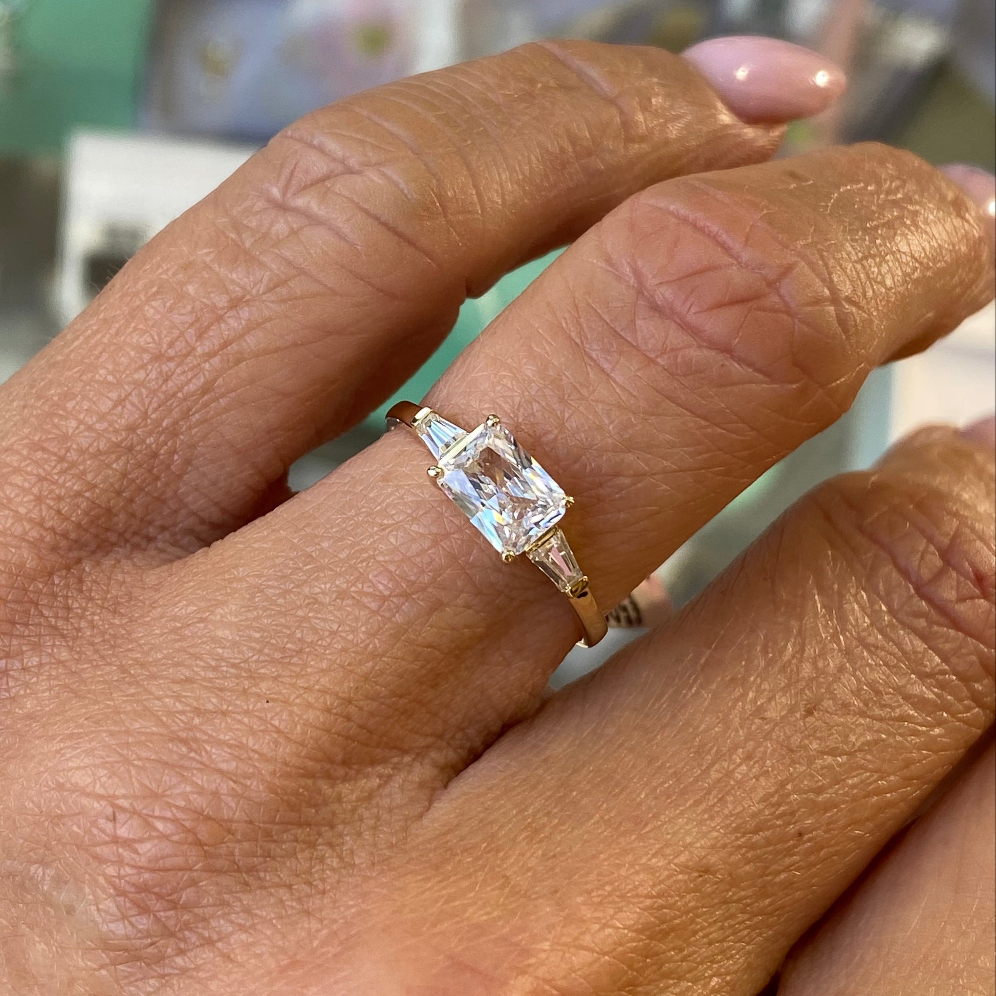 Insignia 9ct gold east west ring with cubic zirconia center, showcasing a sleek, modern design and polished finish.