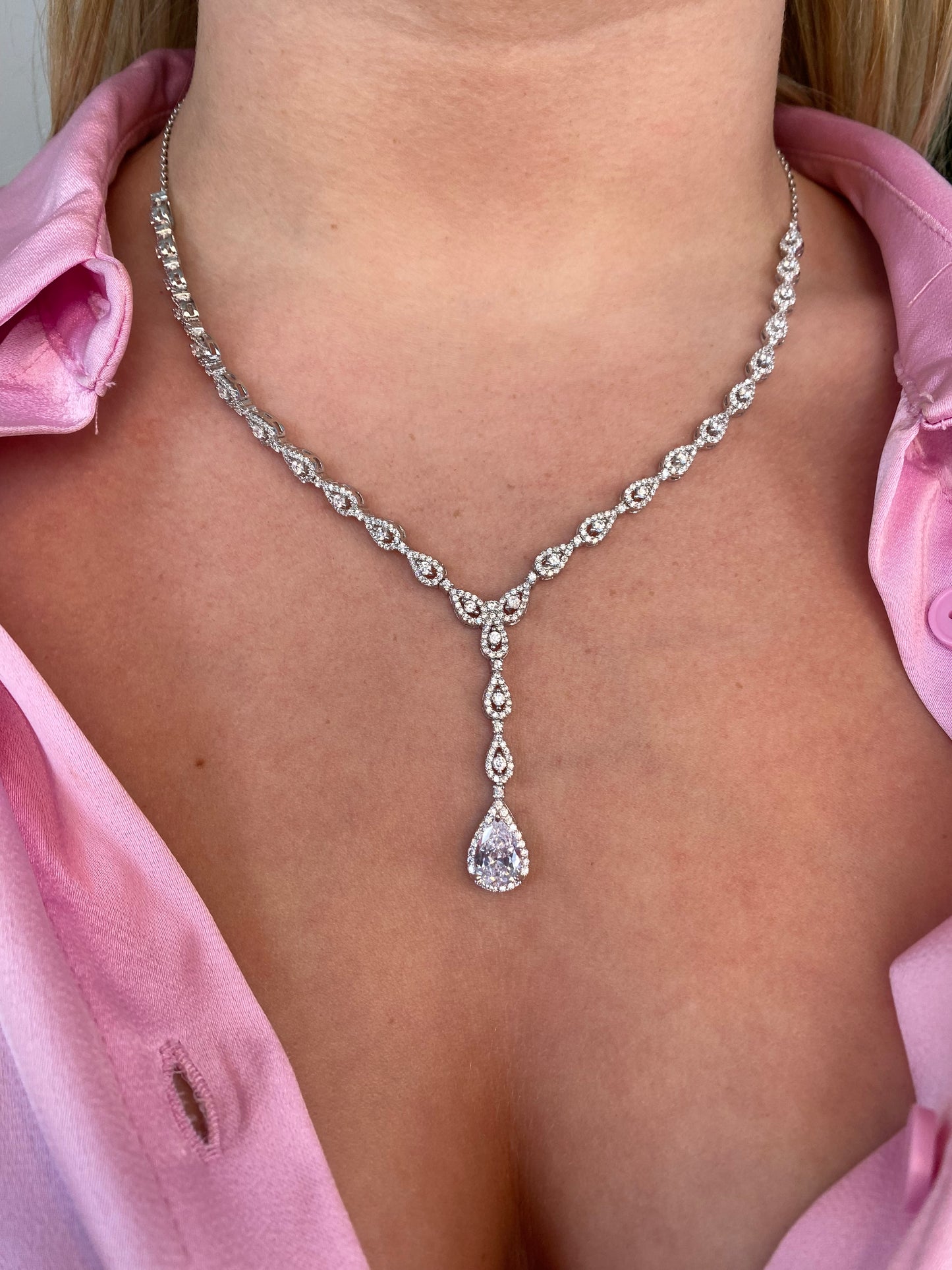Silver Emilie Necklace by Comero featuring a delicate chain with a subtle pendant, displayed against a neutral background.