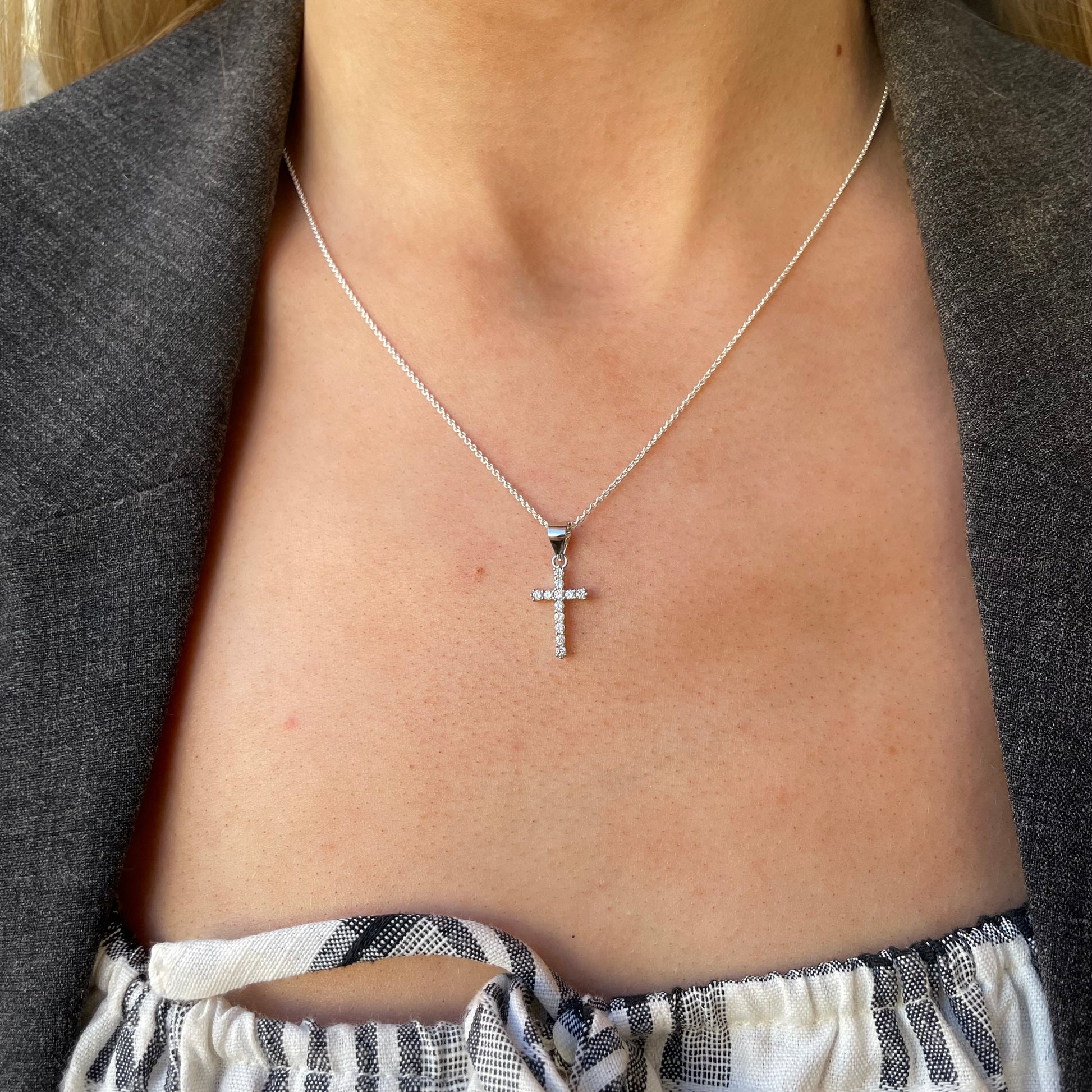 Silver CZ cross necklace on an 18-inch chain by Comero showcasing a sparkling cross pendant.