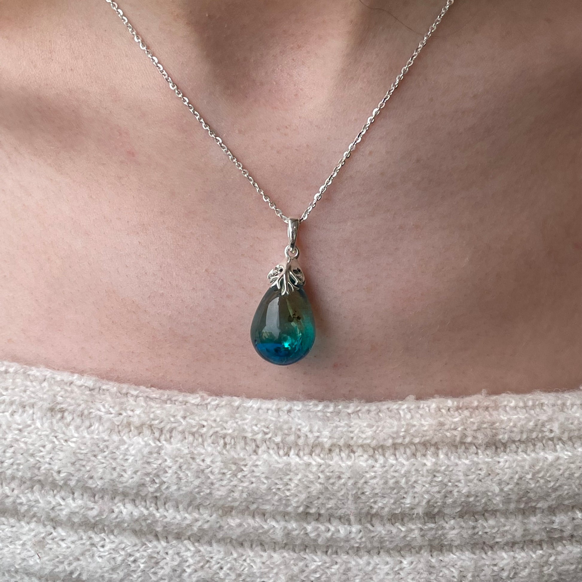 Silver Baltic Amber pendant necklace featuring a polished amber gemstone on a silver chain, crafted by CME.