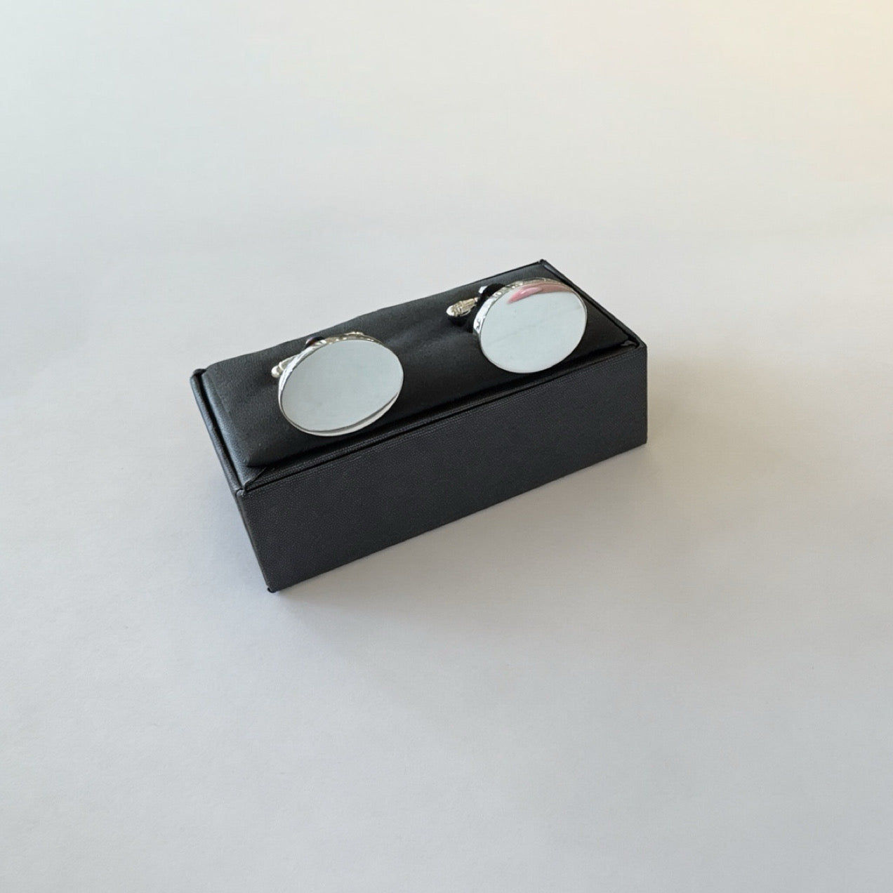 Rhodium plated oval cufflinks by Clandela featuring polished silver finish and classic design for formal wear.