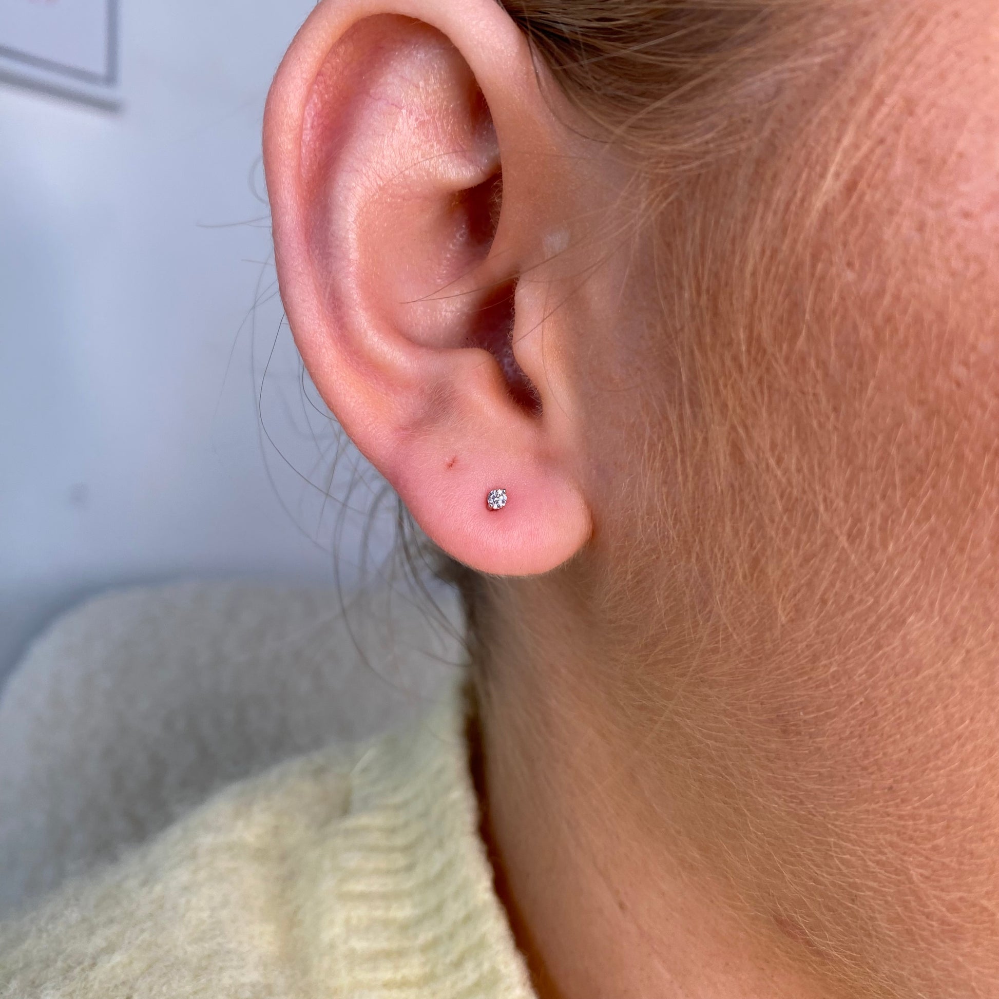 Silver 1.5mm CZ nano stud earrings for kids by Comero, featuring small sparkling cubic zirconia stones on a silver setting.