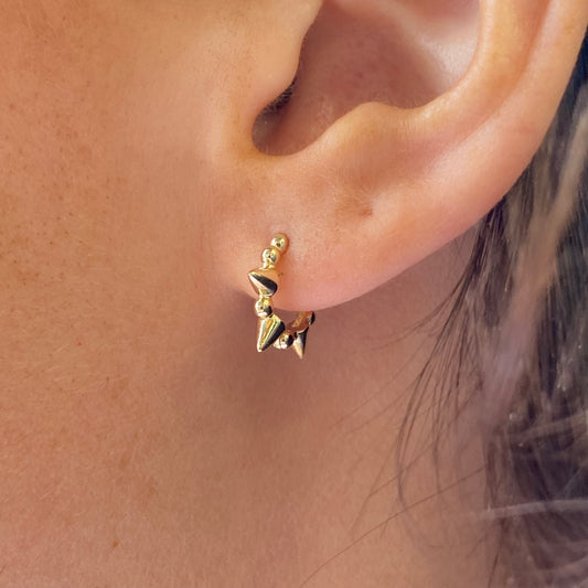 Gold Sunshine Spiked Huggie Hoop Earrings by Comero, close-up of trendy earrings with spiked design and hoop shape.
