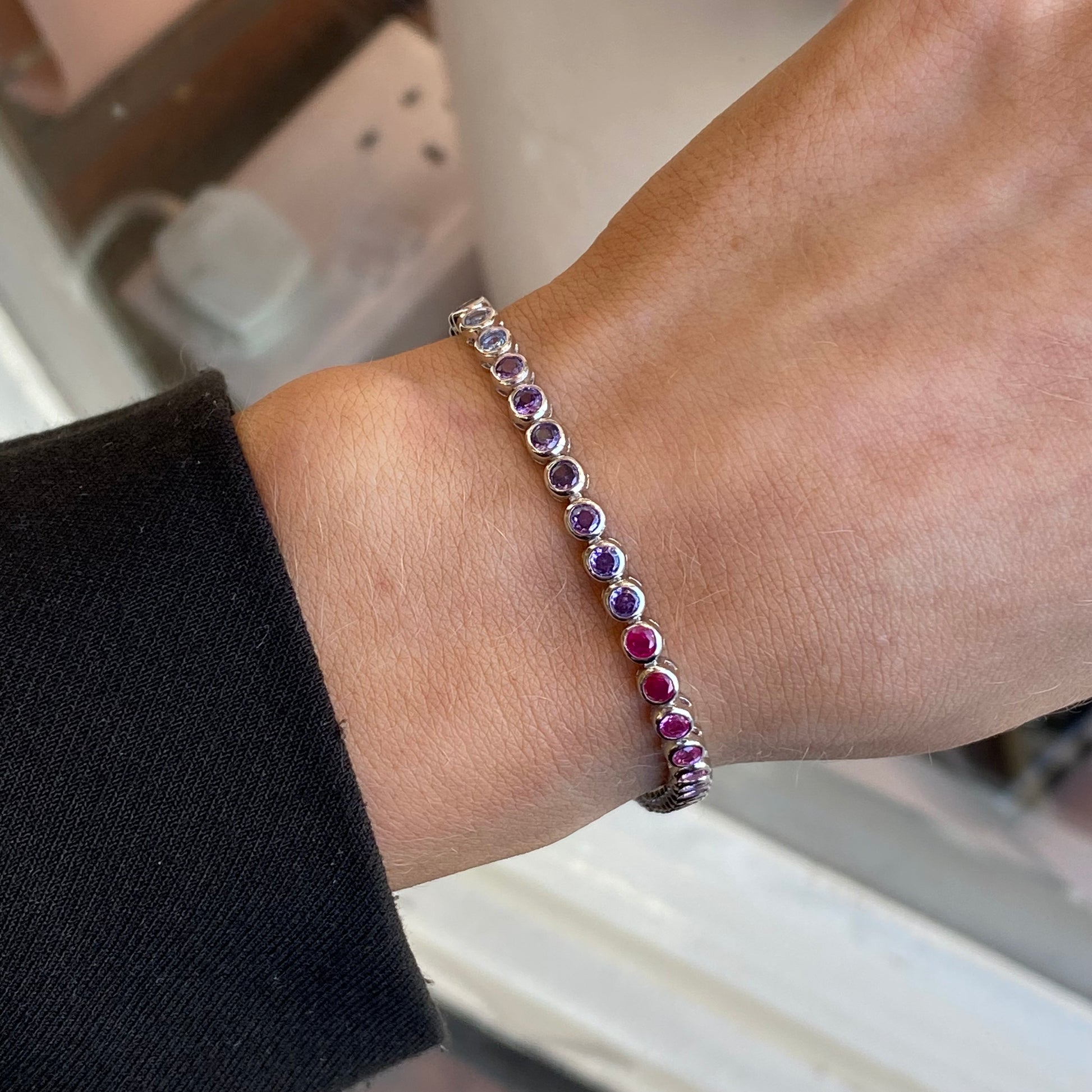 Silver CZ rub-over tennis bracelet with rainbow pastel stones, featuring a sleek and elegant design by Insignia.