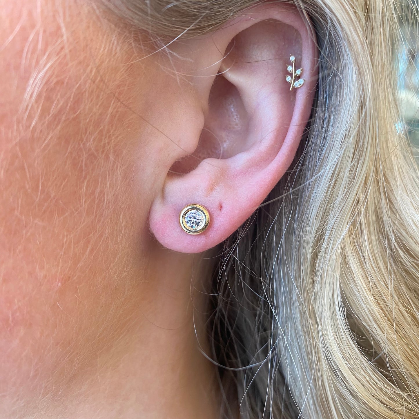 NJO 9ct gold bezel set cubic zirconia stud earrings with a classic round design and secure post back.