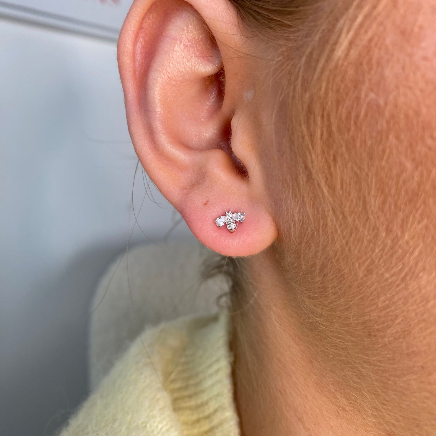 Silver CZ bee stud earrings for kids by Comero, featuring sparkling cubic zirconia and a cute bee design.