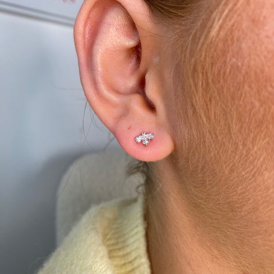 Silver CZ bee stud earrings for kids by Comero, featuring sparkling cubic zirconia and a cute bee design.