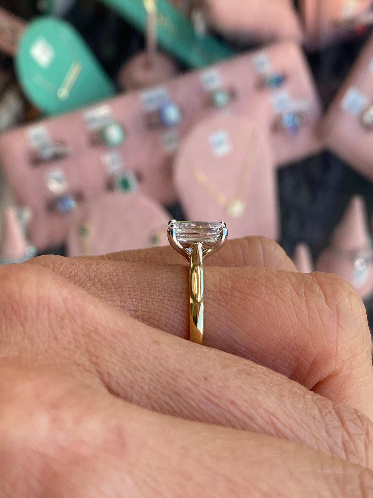 18ct gold emerald cut solitaire engagement ring with a 2.58ct certified lab gemstone by Domino, showcasing a sleek and elegant design.