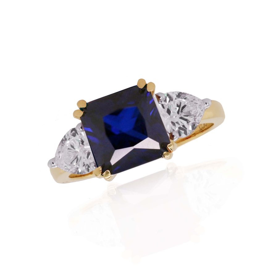 Elegant 9ct gold created sapphire and cubic zirconia ring by Mark Milton, showcasing a sparkling blue gemstone and intricate band design.
