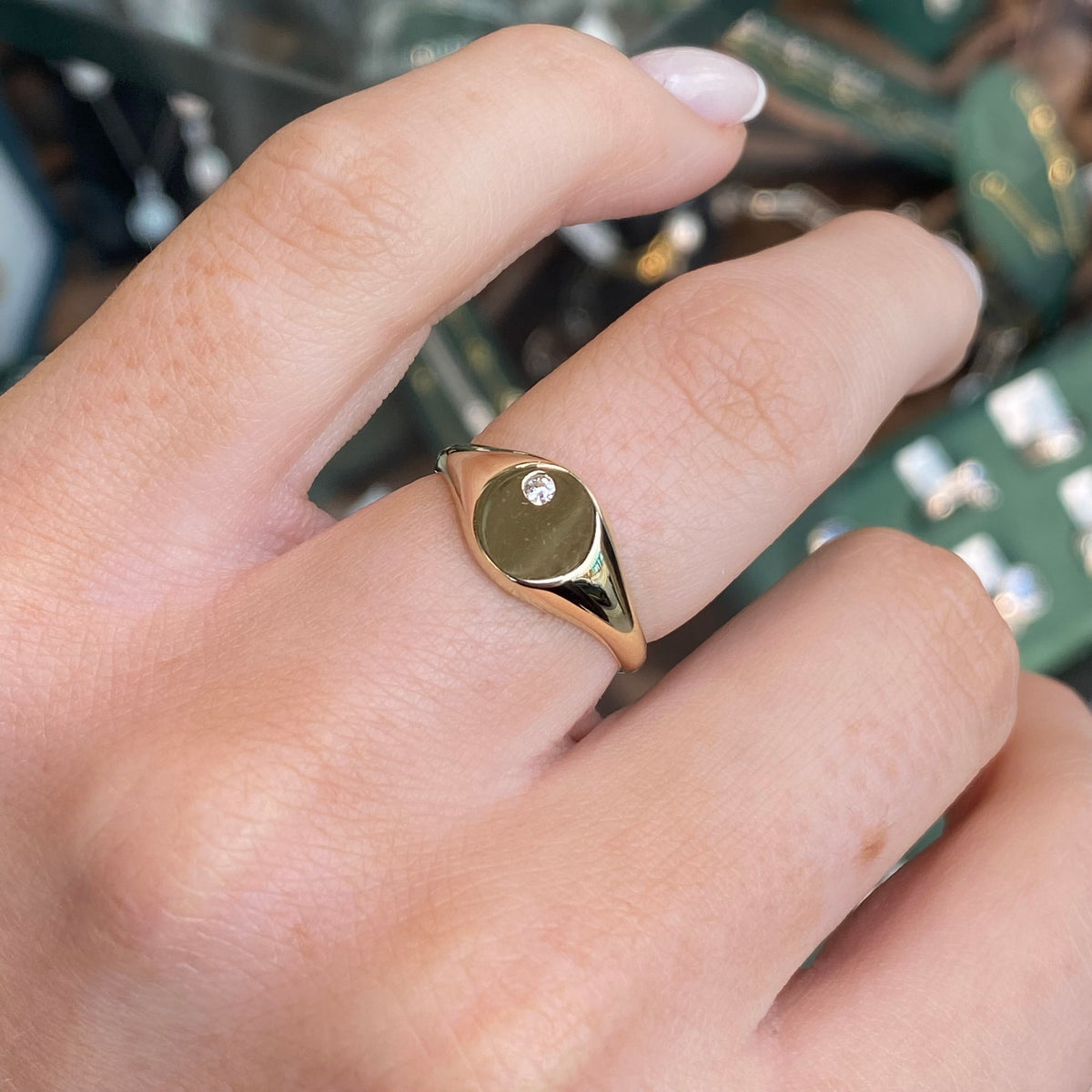NJO 9ct gold round CZ signet ring showcasing a polished gold band with a round cubic zirconia centerpiece.
