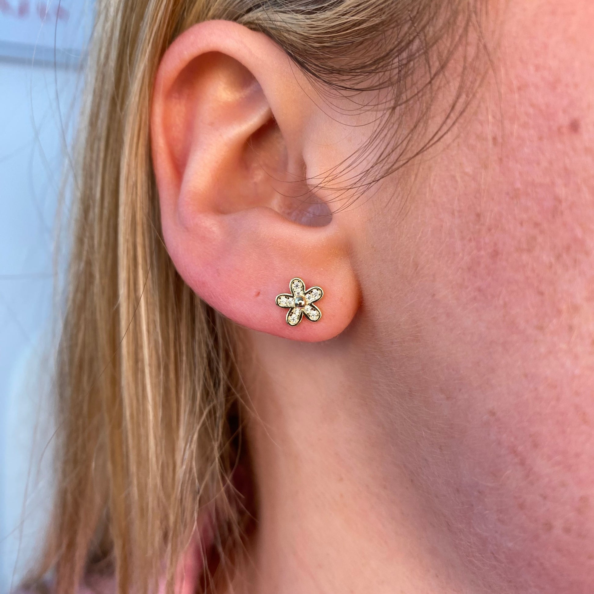 Insignia Sunshine CZ flower stud earrings featuring sparkling cubic zirconia blossoms on silver-tone metal.