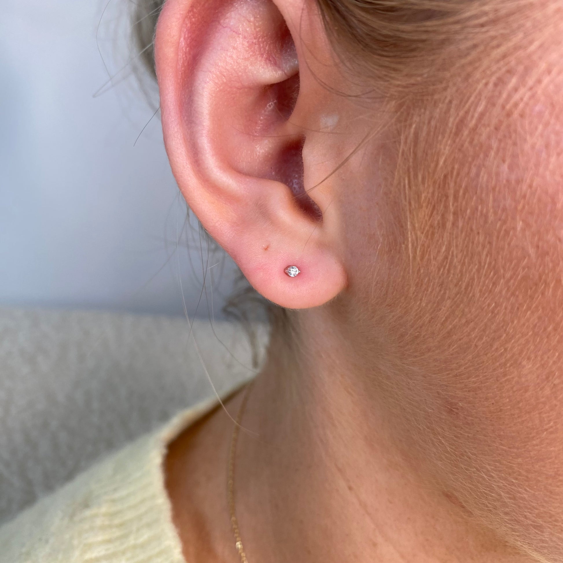 Silver nano CZ stud earrings for kids by Comero, featuring sparkling cubic zirconia stones on small silver posts.