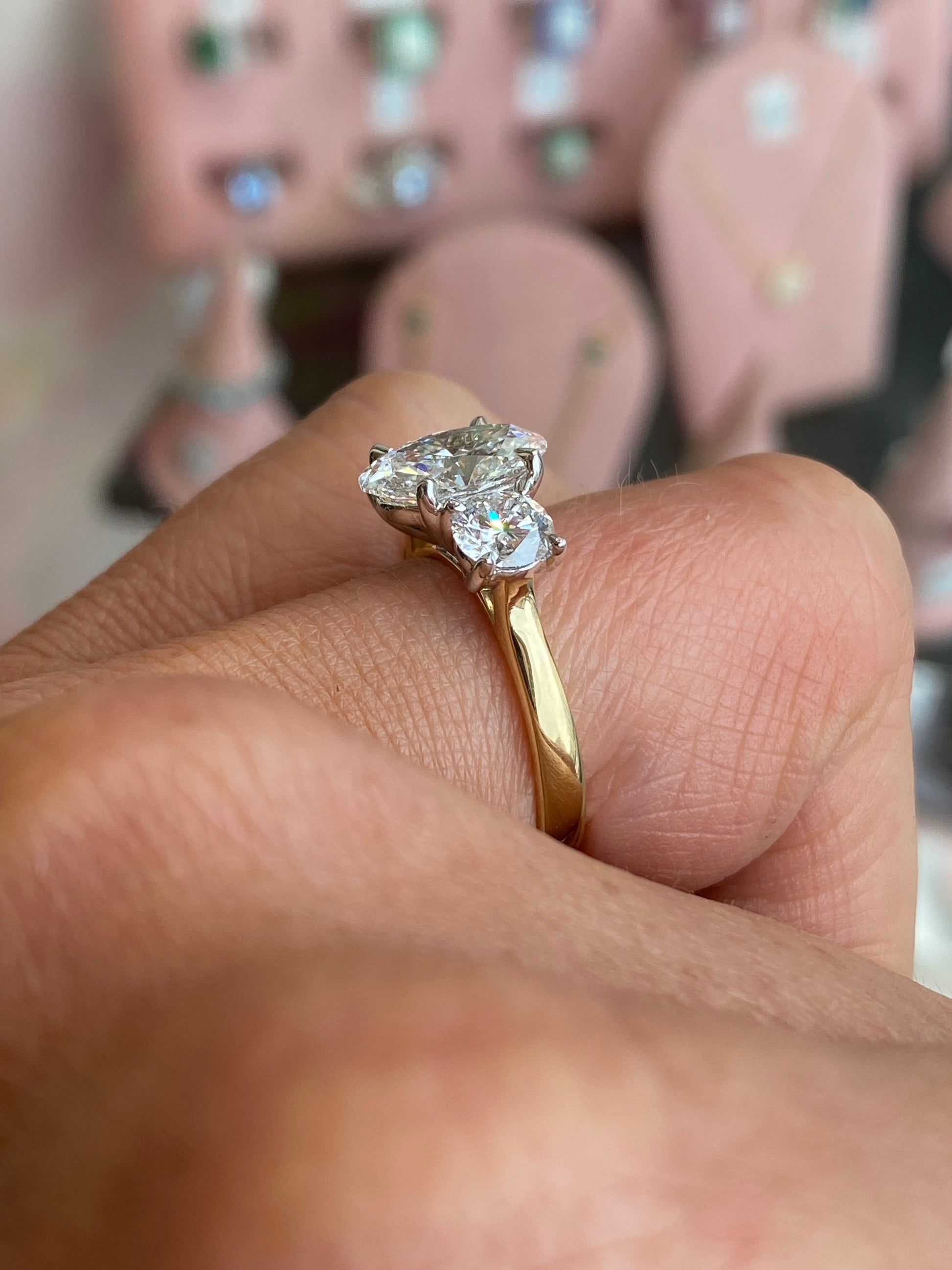 18ct gold oval trilogy engagement ring by TCA with lab-certified 3.15ct diamonds, featuring three sparkling oval stones in a classic design.
